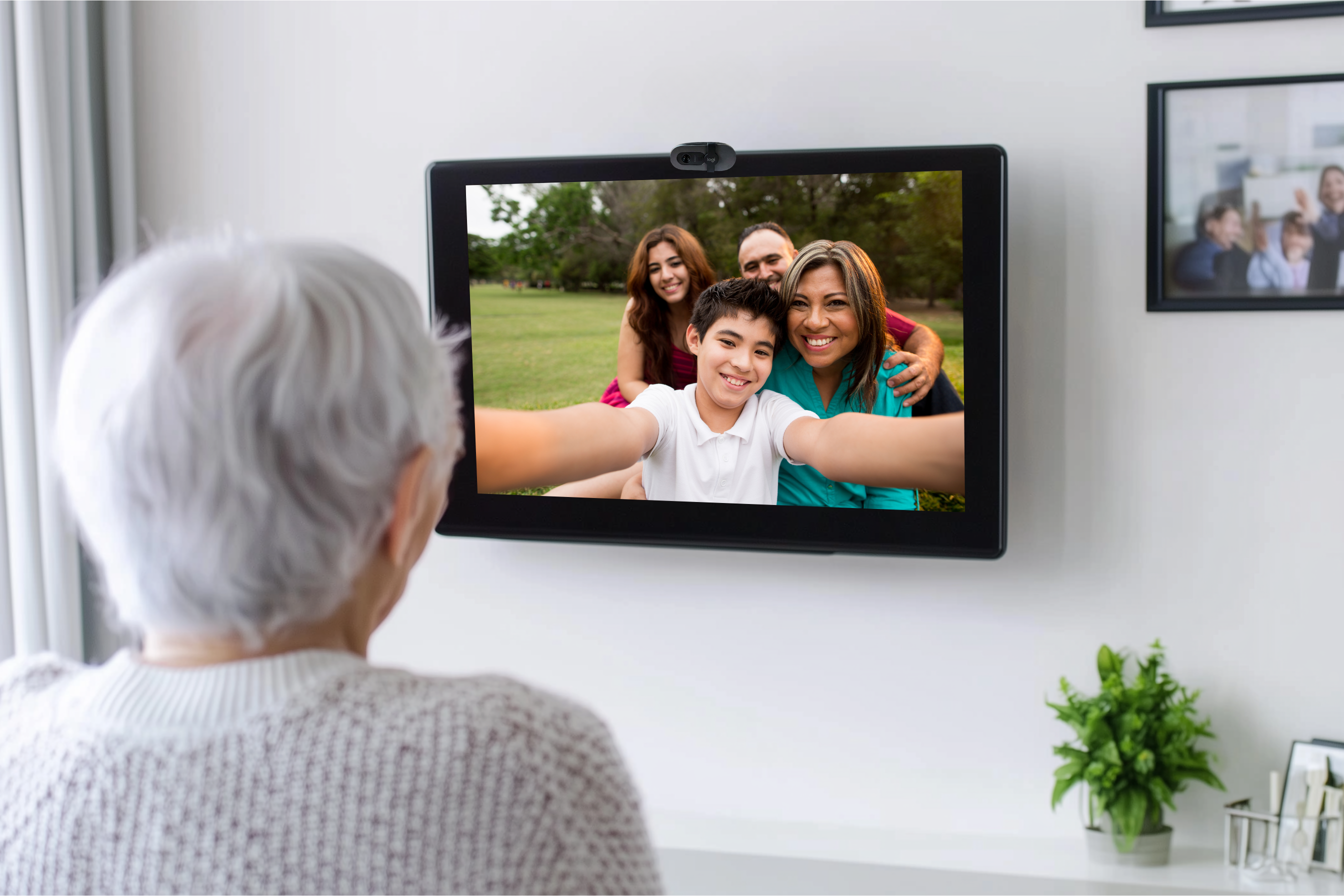 Elderly woman watching her family using CallGenie